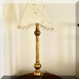 DL03. One of a pair of gold tone table lamps with beaded shades.